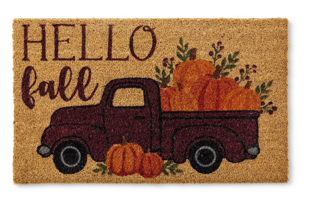 fall front doormat that says hello fall with a pickup truck full of pumpkins